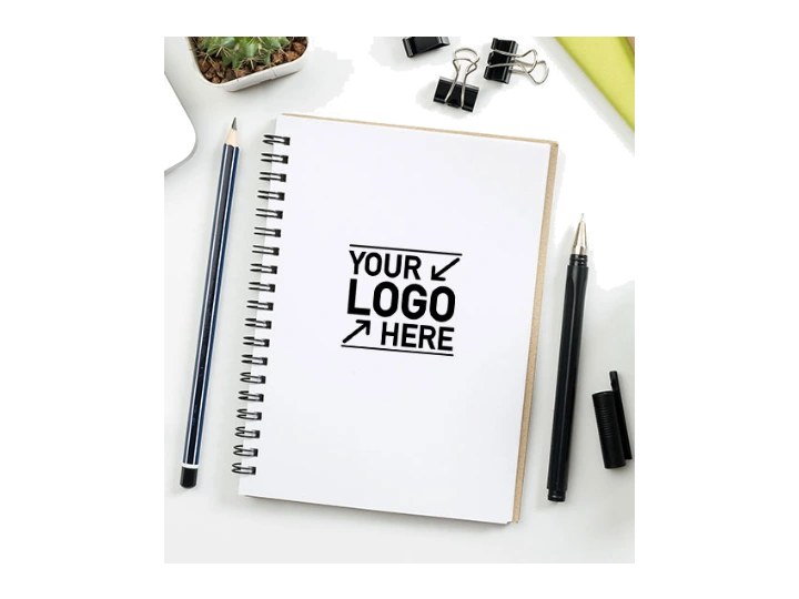 Catalog photo of a branded notebook with pens on a desk