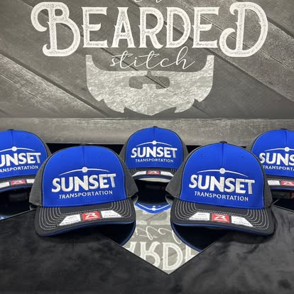 Blue Sunset Transportation custom caps displayed together